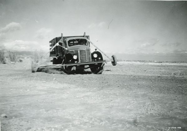 Front view of an International Model KB-7 working through a special "Figure 8" wheel and wheel bearing breakdown test, possibly at International Harvester's Phoenix Proving Grounds.