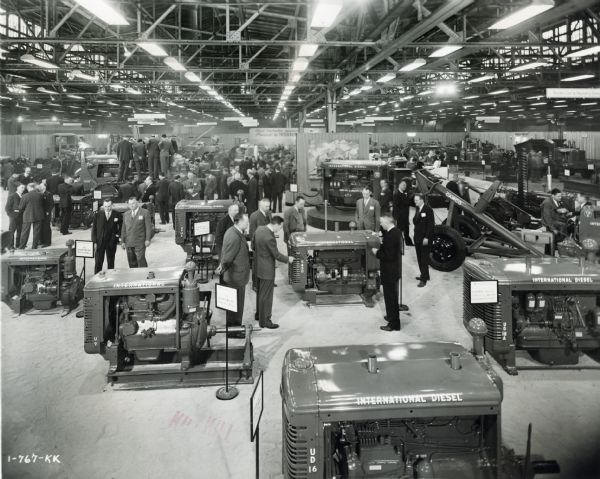 Men examine International power units and other machinery on display in the Industrial Power Exhibit for Allied Equipment Manufacturers.  The exhibit took place at International Harvester's Melrose Park Works.