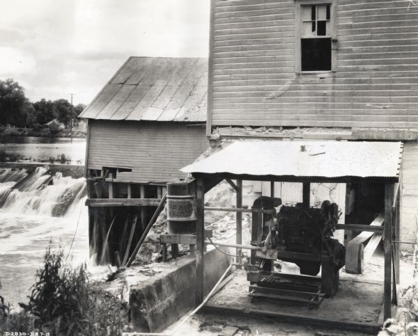International PD-40 power unit in use at a mill owned by Asa Shait & Son Milling Company. A waterfall is in the background near the mill.