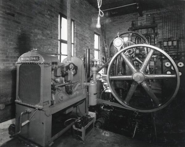 Interior view of the municipal water plant pump house showing the auxiliary and emergency pump units, powered by an International P-30 power unit.