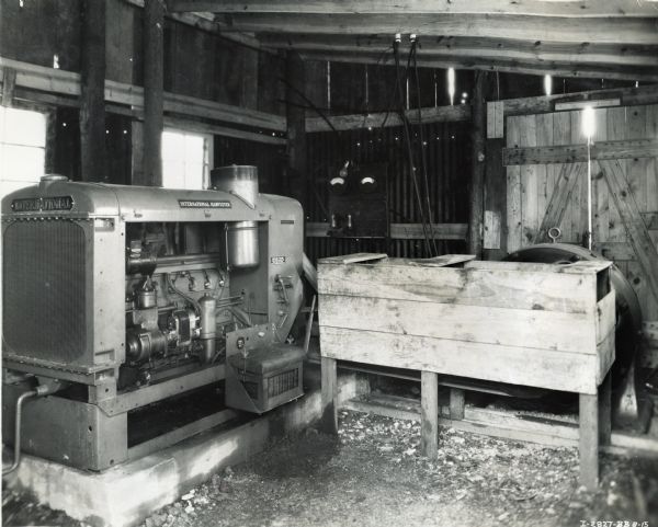 International PA-50 power unit owned by T.E. Luman, which is housed inside a wooden building. The unit was used to generate power to run a coal cutter, lights, and a fan.