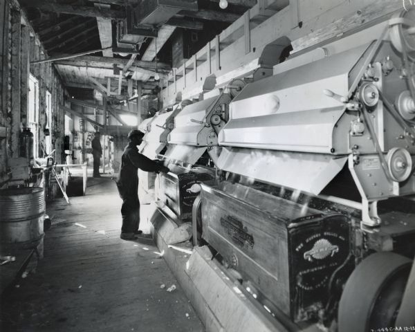 Workers tend machinery powered by an International PD-80 power unit at the Wilmot Gin Company.