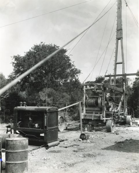 A Star heavy-duty 45-C spudder rig and an International PD-80 diesel power unit stand on a building site at Martin Hoffman, No.3, Forest Development Company.
