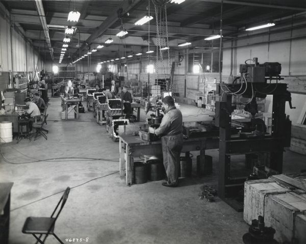 Male and female workers assemble pieces of air-borne invasion tanks at International Harvester's Indianapolis branch house.