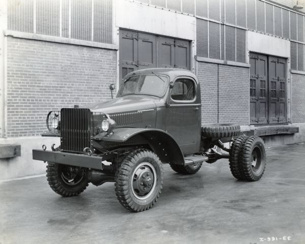 Three-quarter view towards the front driver's side of an International 1 1/2 ton cargo M-3-4 M.T. truck. The truck was sold to the U.S. Marine Corps.