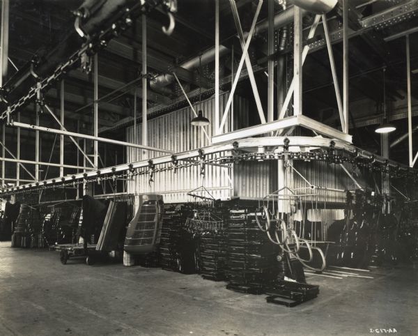 Truck parts are transported by an overhead factory conveyor system at International Harvester's Springfield Works.