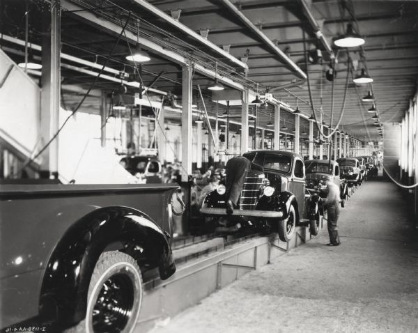 Factory workers on an International truck assembly line, possibly at the Springfield Works.