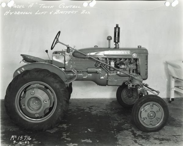 Engineering right side profile view of a Farmall A tractor, possibly experimental. The text on the photograph reads: "Model 'A' Touch Control Hydraulic Lift & Battery Box."
