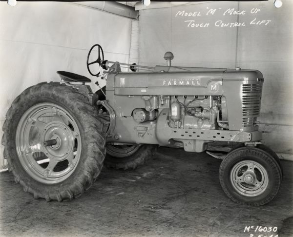 Engineering photograph of a Farmall M tractor. The text on the photograph reads: "Model 'M' Mock Up Touch Control Lift."