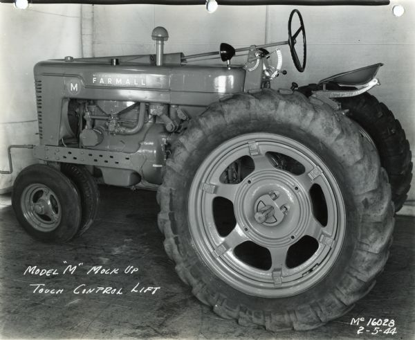 Engineering photograph of a "mock-up" Farmall M tractor. The text on the photograph reads: "Model 'M' Mock Up; Touch Control Lift."