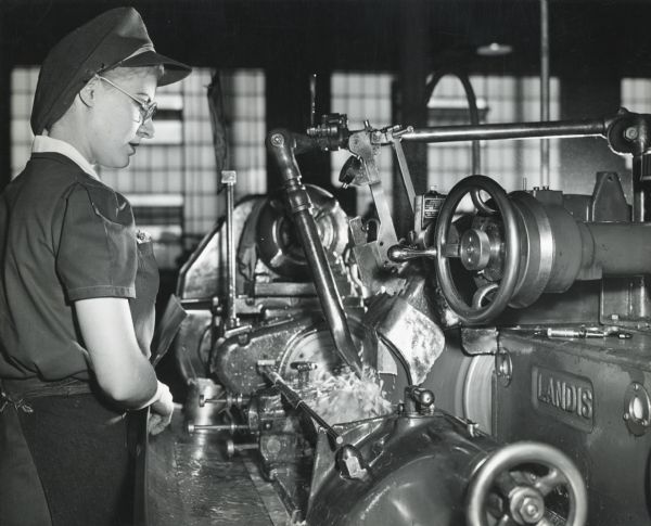 Factory worker Lorraine Larsen, a lathe operator, tends to a bolt body for the 20 mm cannon at International Harvester's St. Paul Works.