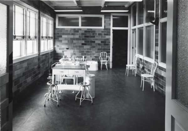 Tables, stools, and chairs in the Dispensary and Dressing Room of International Harvester's Quad Cities Tank Arsenal.