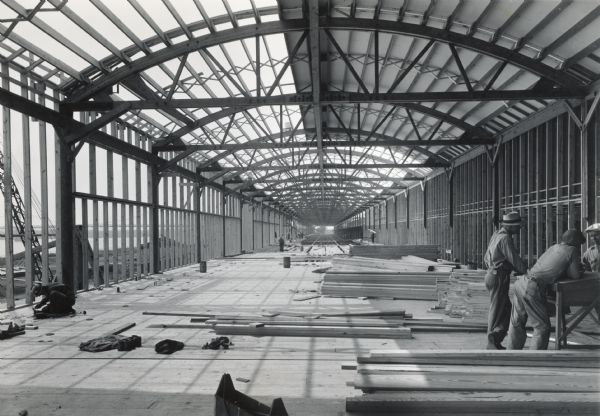 Men work on the interior of a partially constructed building at International Harvester's Quad Cities Tank Arsenal.