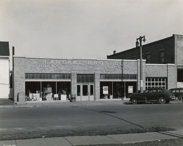 View from across street of the Landaal Brothers Company storefront. Landaal Brothers was an International Harvester dealership managed by Alfred Galler.