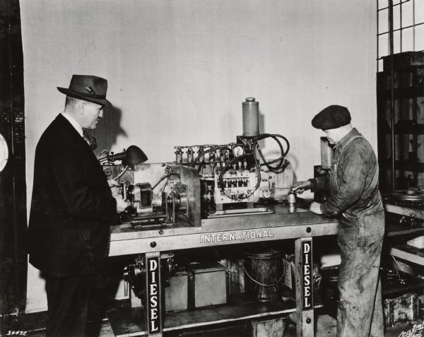A mechanic calibrates a fuel injection pump for a TD-18 crawler tractor (TracTracTor) at J.D. Adams Co., an International Harvester dealership.