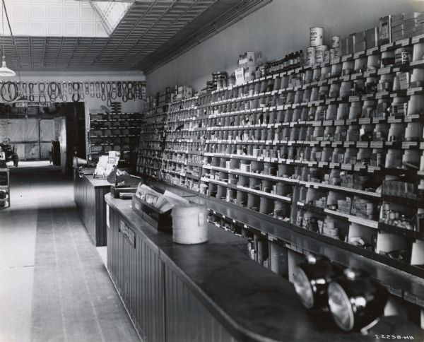 Service and parts counter of the Hede Implement Company, an International Harvester dealership. A tractor is parked in a room in the background.