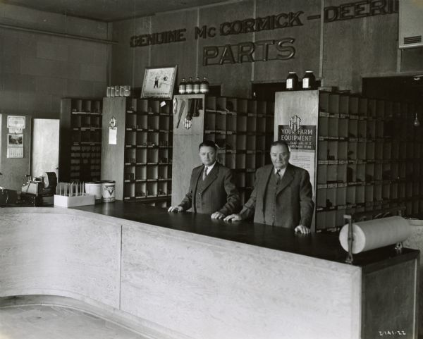 C.O. Johnson (right) and his son Harold at the parts counter of their International Harvester dealership.
