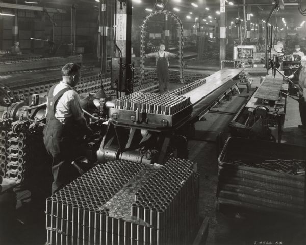 Factory workers making parts at International Harvester's Tractor Works.