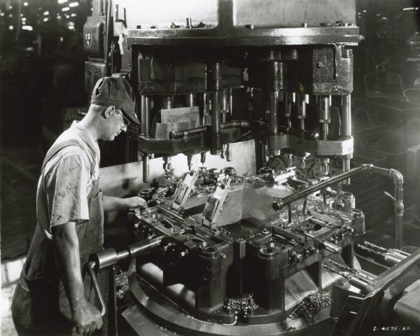Factory worker at a drill press in International Harvester's Tractor Works.