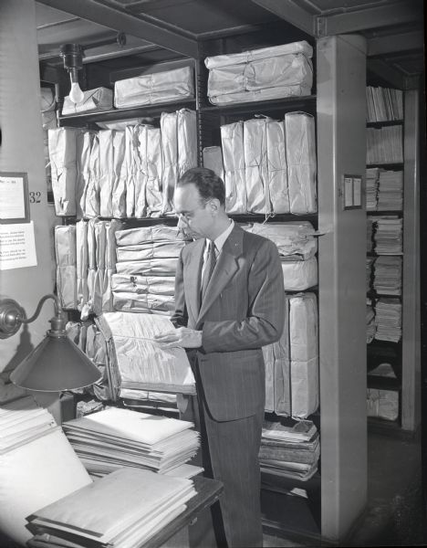 Benton H. Wilcox, Librarian of the State Historical Society, examining manuscript materials in the McCormick Collection, recently received at the Society.