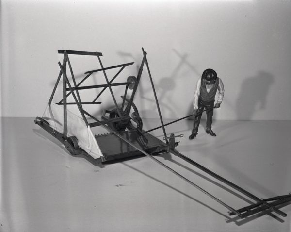 Scale model of a McCormick hand-rake reaper.