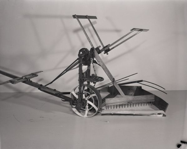 Scale model of a McCormick reaper with automatic self-delivery attachment.