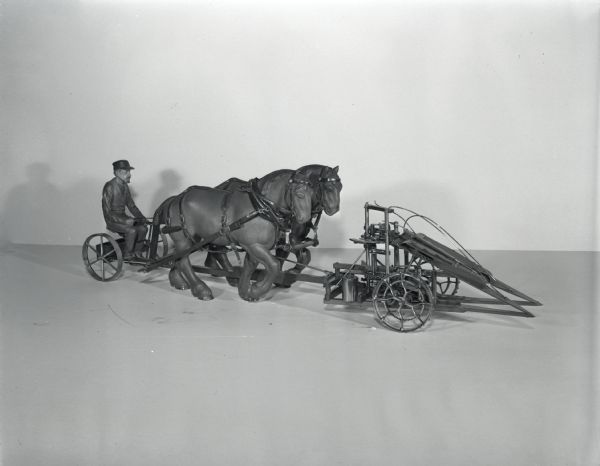 Scale model of a McCormick push-type corn binder.