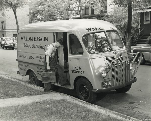 Man, possibly William E. Bahn, boarding International Metro truck.