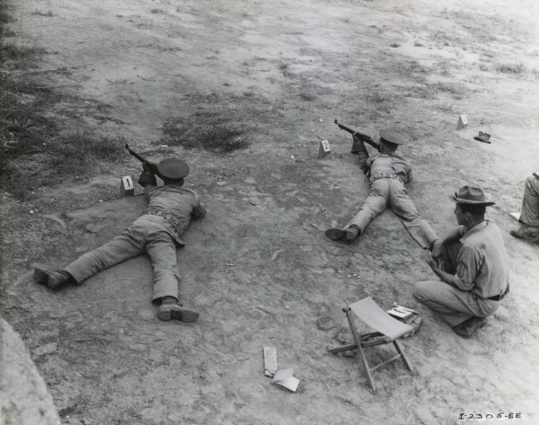 Overhead view of U.S. Marines firing rifles, possibly at a Marine Corps rifle range.