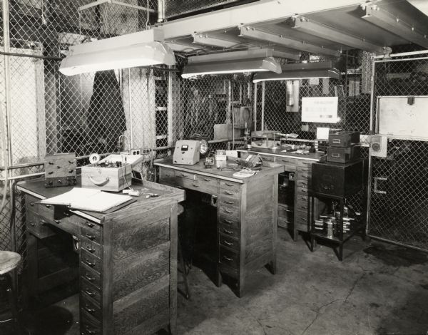 Interior view of factory workstations in the Instrument Checking and Repairing Department at International Harvester's Tractor Works.
