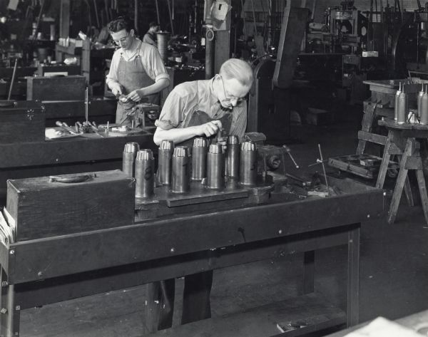 Two factory workers repairing metal-patterns in Foundry Metal Pattern Department at International Harvester's Tractor Works.