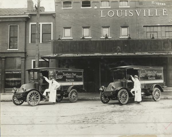 Two drivers for "Southern Star Products" out of Louisville Provision Company pose next to International model F, or 31 trucks. The trucks are parked outside the Louisville Provision Co. building. "Southern Star" was a brand applied to lard, bacon, and hams.