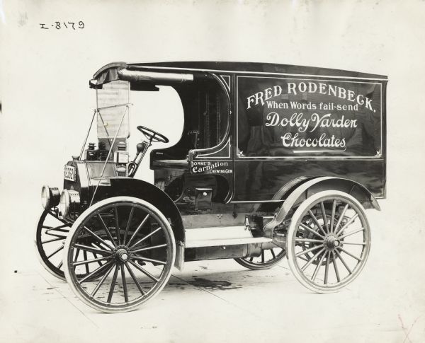 International Model M truck operated by Fred Rodenbeck confections. The side of the truck advertises Dolly Varden chocolates.