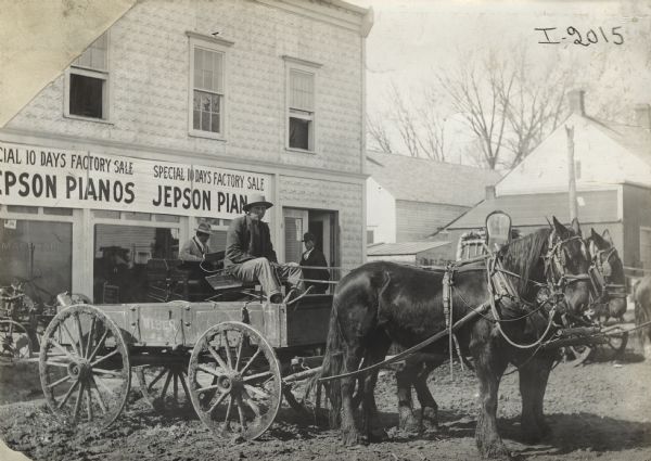 Man sitting in horse-drawn Weber wagon outside the Jepson piano store.