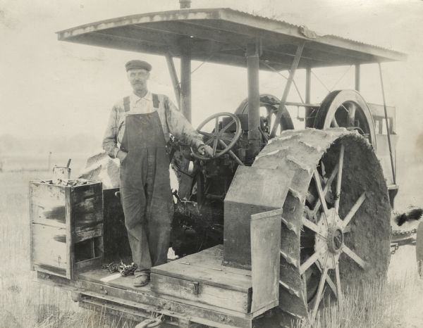 Man with a Titan tractor on farmland.