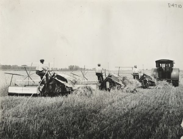Mogul 25 h.p. tractor pulling three McCormick grain binders.
