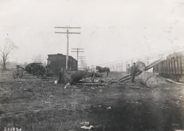 Mogul 8-16 tractor used to power a lifting outfit to load large logs onto freight car.