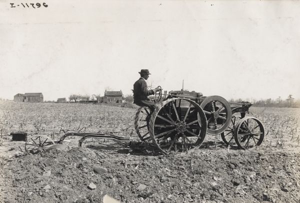 Man plowing a field with a Mogul 8-16 tractor.