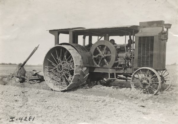 Mogul tractor with a plow in a field.