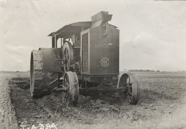Front view of a Mogul 45 h.p.(?) tractor in a field.