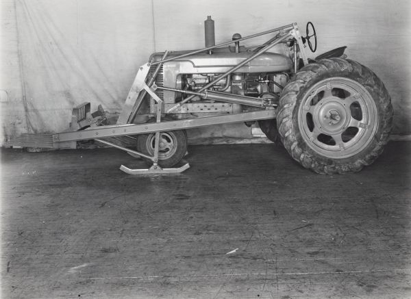 Engineering photograph of a Farmall tractor with a No. 30 power loader. The equipment may be experimental.