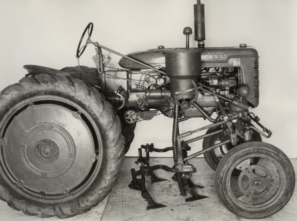 Engineering right side profile view of a Farmall AV tractor equipped with a No. 144 cultivator with side dressing attachment.