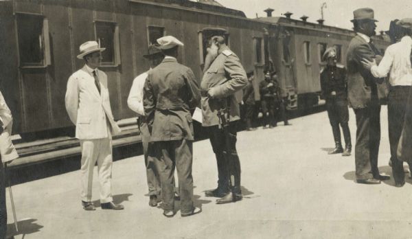 Men standing near the Imperial train carrying members of the Root Commission at a railroad station. Original caption reads: "General Horwaeth, chief of Russian forces and interests in Manchuria and president of the Chinese Eastern Ry. [Railway]."