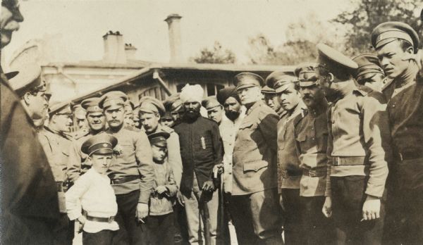 Group of uniformed men and boys standing with two men wearing turbans. Original caption reads: "Gen'l Scott, Sihko and group of Russian soldiers at Oceanskaya."