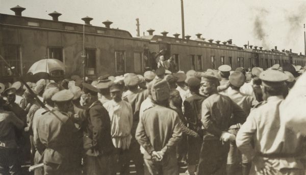 Senator Elihu Root addressing Russian soldiers at Perm. Root is standing near the Imperial train that carried members of the Root Commission.