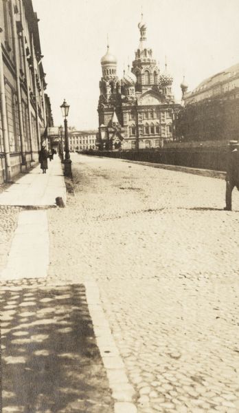View down a Petrograd (St. Petersburg) street with the Church of the Resurrection in the background.