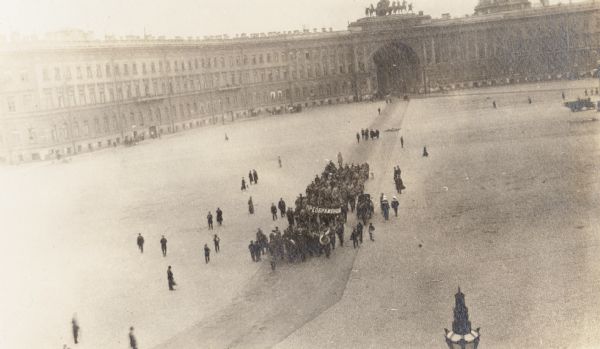 Elevated view of a procession makings its way through the grounds of the Winter Palace at Petrograd (St. Petersburg), Russia. Original caption reads: "'Battalion of Death' passing the Winter Palace."
