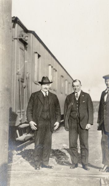 Admiral Glennon (left), Cyrus McCormick, Jr. (center) and "Gorbatenka" standing near a train in Russia.