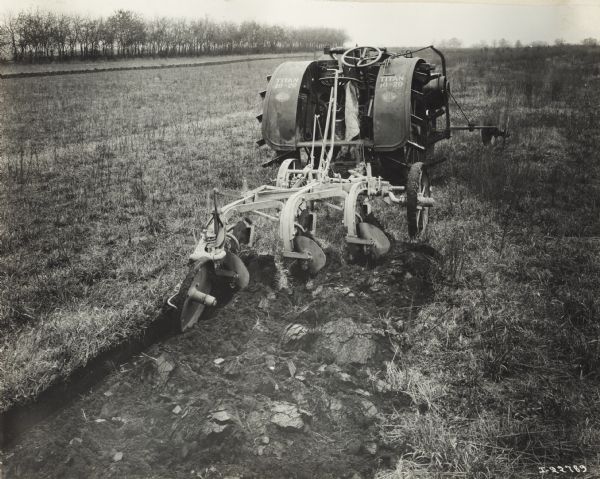 Titan 10-20 tractor in a field with a P&O tractor plow.
