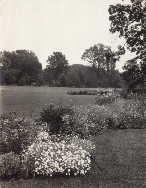 Elizabeth Park in Hartford, Connecticut. View of a small portion of the park's property bordered by plants. The original caption describes it as "well-planned landscaping."